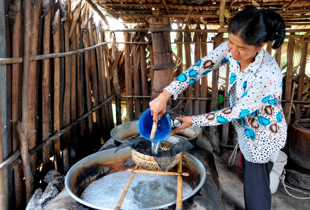 Nước thốt nốt được người dân nấu thành đường hoàn toàn bằng phương pháp thủ công với chiếc chảo gang đặt trên lò đất đỏ lửa. 10 lít nước thốt nốt sẽ được nấu trong vài giờ để tạo ra 1kg đường ngọt thanh tự nhiên, không sử dụng phụ gia. Ảnh: An Hiếu - Báo ảnh Dân tộc và Miền núi