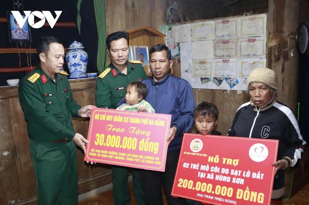 Đại tá Trần Hữu Ích, Chỉ huy trưởng Bộ Chỉ huy Quân sự thành phố Đà Nẵng (ngoài cùng bên trái) trao tiền hỗ trợ các gia đình.