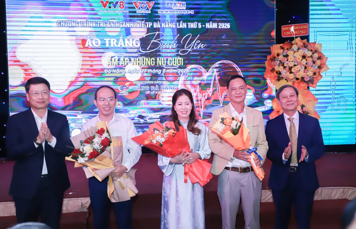 Phó Bí thư Thành ủy Ngô Xuân Thắng (bên trái) tặng hoa chúc mừng vợ chồng chị Lanh cũng như đại diện ê kíp ghép gan cho chồng chị Võ Thị Lanh. Ảnh: NGỌC PHÚ