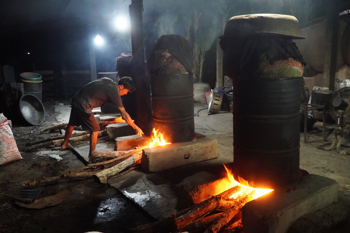 Người thợ phải canh lửa đều tay liên tục suốt hai giờ đồng hồ từ lúc nước sôi để bánh chín đều và giữ vẹn nguyên hương vị thơm ngon. Ảnh: Trần Tuấn