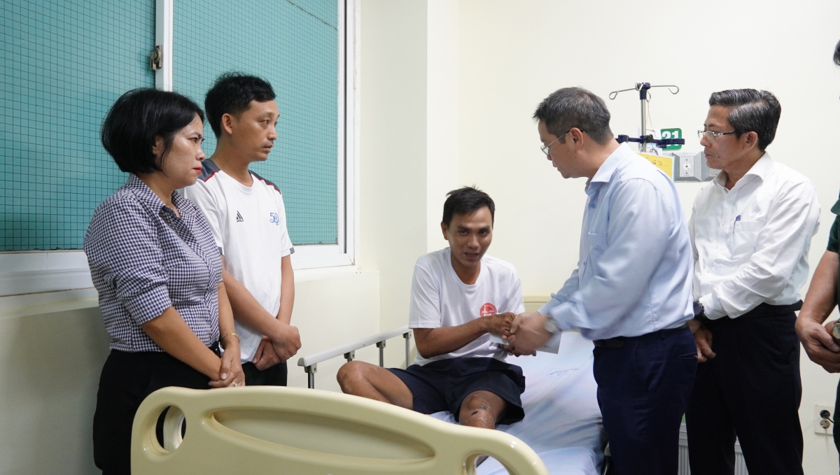 Ông Nguyễn Mạnh Hùng, Chủ tịch UBDN thành phố Đà Nẵng (bắt tay ngư dân) ân cần, thăm hỏi thăm sức khỏe ngư dân gặp nạn trên biển vừa được cứu sống trở về